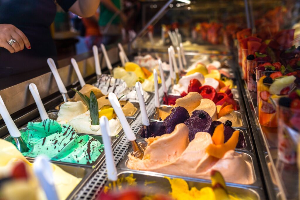 A Gelato parlour with a variety of ice cream flavours in tubs.