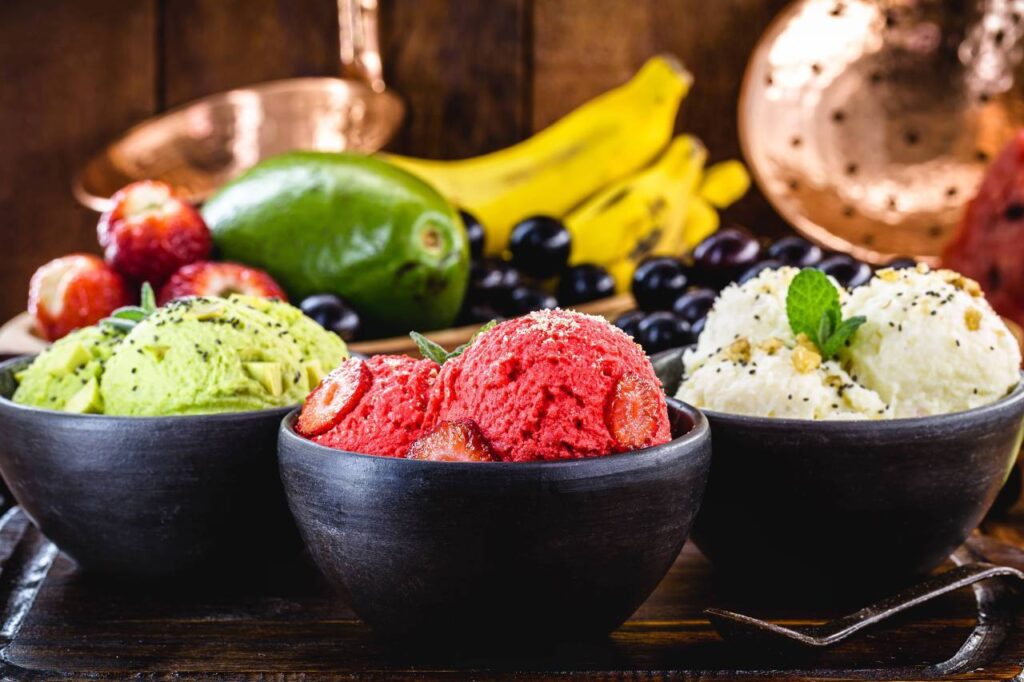 A variety of vegan gelato scoops and fruits.