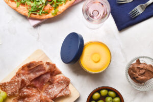 Spread of food on marble table of Italian food, meats, pasta, pizza.